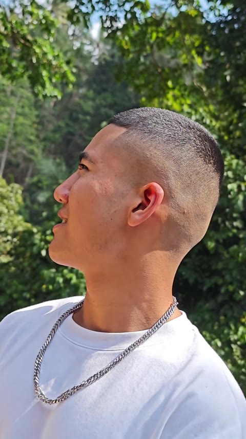 Short buzz cut with a clean fade, seen in profile